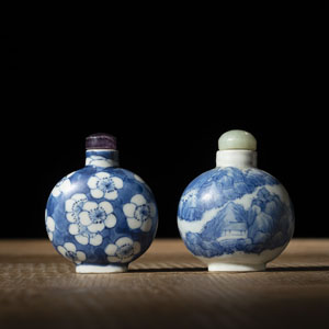 <b>TWO BLUE AND WHITE PORCELAIN SNUFF BOTTLES DEPICTING PLUM BLOSSOMS AND A MOUNTAIN LANDSCAPE</b>