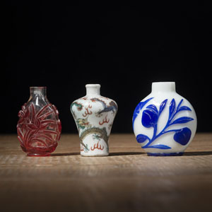 <b>TWO RED- AND BLUE-OVERLAY BEIJING GLASS AND A POLYCHROME DRAGON PORCELAIN SNUFFBOTTLE</b>