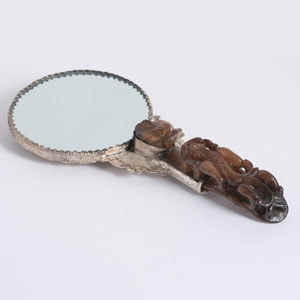 <b>A JADE BELT HOOK MOUNTED AS A SILVERED-COPPER HAND MIRROR</b> <b>A JADE BELT HOOK MOUNTED AS A SILVERED-COPPER HAND MIRROR</b>