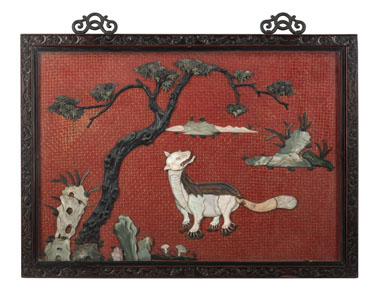 <b>A LARGE CINNABAR-LACQUER-GROUND JADE- AND STONE-INLAID MYTHICAL BEAST PANEL IN FINELY CARVED FRAME</b>