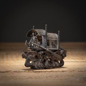 <b>A SILVER MINIATURE SHIP WITH AN OARSMAN, ON A MATCHING WOODEN BASE</b>
