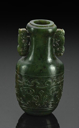 <b>A SPINACH-GREEN JADE VASE IN ARCHAIC STYLE WITH LARGE TAOTIE MASKS</b>