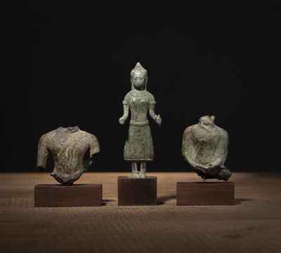 <b>TWO BRONZE TORSO FRAGMENTS AND A STANDING BUDDHA</b>