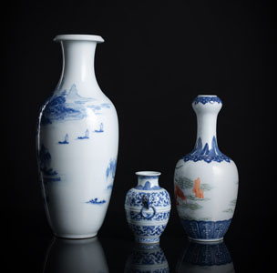 <b>A GROUP OF THREE BLUE AND WHITE PORCELAIN VASES, ONE WITH ADDITIONAL DECORATED FAMILLE ROSE SCENE</b>