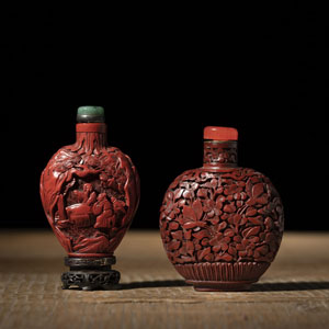 <b>TWO RED LACQUER CARVED SNUFF BOTTLES DEPICTING FLOWERS, BIRDS AND SCHOLARS</b>