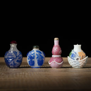 <b>FOUR PEKING GLASS SNUFF BOTTLES WITH POLYCHOROME FLORAL AND LANDSCAPE DECORATION, PARTLY WITH BLUE OVERLAY</b>