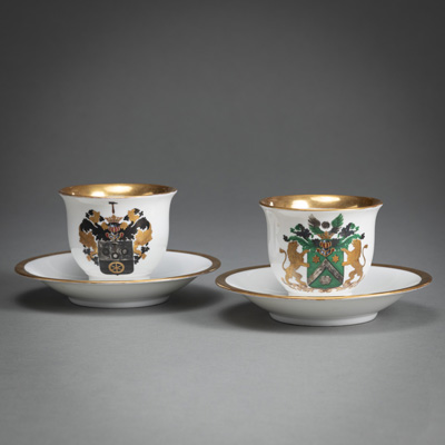 <b>TWO PARTIAL GILT PORCELAIN CUPS AND SAUCERS WITH COAT OF ARMS</b>