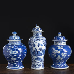 <b>A PAIR OF BLUE AND WHITE PRUNUS PORCELAIN VASES AND COVERS AND AN ADDITIONAL VASE AND COVER</b>