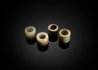 <b>A GROUP OF FOUR  JADE ARCHER'S THUMB RINGS</b>