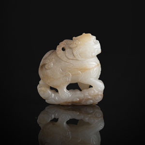 <b>A CARVED GREEN-BEIGE JADE PENDANT OF A MYTHICAL BEAST</b>