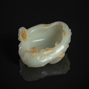 <b>A ROCK-SHAPED GREEN AND CARAMEL JADE BRUSHWASHER WITH BIRD AND FLOWER BRANCH</b>