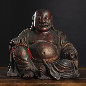 <b>A LACQUERED WOOD FIGURE OF BUDAI HOLDING A KERNEL BEAD BRACELET</b> <b>A LACQUERED WOOD FIGURE OF BUDAI HOLDING A KERNEL BEAD BRACELET</b>