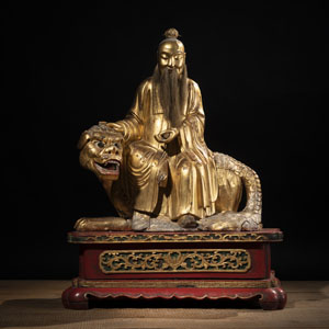 <b>A LACQUER-GILT WOOD FIGURE OF 'TAIYI TIANZUN' SEATED ON A LION</b>