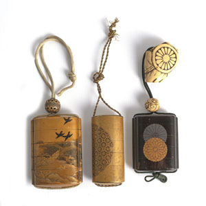 <b>THREE GOLD-LACQUERED INRO DECORATED WITH A LANDSCPE SCENE AND RAVENS, A MEDALLION AND STYLIZED CHRYSANTHEMUMS  AND WITH A STAGANTLER NETSUKE</b>
