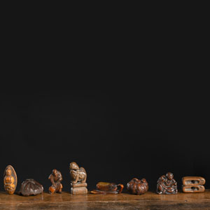 <b>A GROUP EIGHT WOOD AND HORN NETSUKE</b>