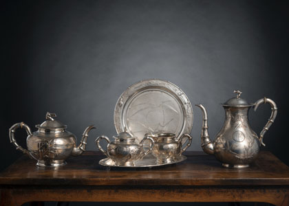 <b>A SILVER SERVICE WITH TEA AND COFFEPOT, A MILK JUG AND A SUGAR BOX AND COVER WITH PLATE AND FURTHER A SILVER DISH</b>