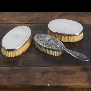 <b>THREE SILVER BRUSHES, ONE WITH FLORAL RELIEF</b> <b>THREE SILVER BRUSHES, ONE WITH FLORAL RELIEF</b>