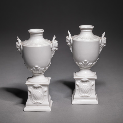 <b>A PAIR OF VASES WITH SATYR HEADS ON POSTAMENTS</b>