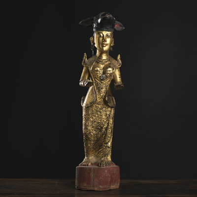 <b>A GILT-LACQUERED WOOD FIGURE OF A FEMALE FIGURE WITH OX-MASK HEADDRESS</b>