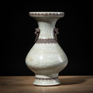 <b>A CELADON CRACKLE-GLAZED RING-HANDLED RELIEF VASE</b>