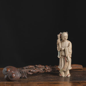 <b>A 'SANXING' RELIEF WOOD 'RUYI' SCEPTRE AND A SOAPSTONE FIGURE OF LAN CAIHE</b>
