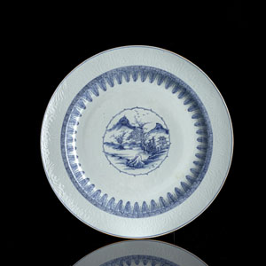 <b>A BLUE AND WHITE LANDSCAPE PORCELAIN CHARGER WITH RELIEF ON THE RIM</b>
