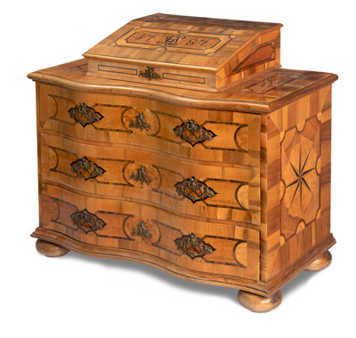 <b>A SOUTH GERMAN BRASS MOUNTED WALNUT BOG OAK AND ROOTWOOD MARQUETRY COMMODE WITH WRITING CASE</b>