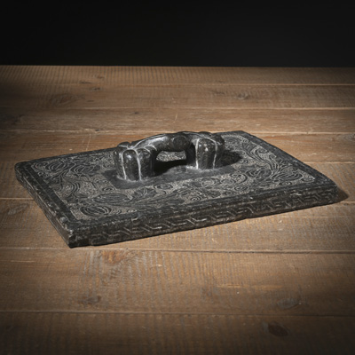 <b>A LOW RELIEF STONE COVER OR WEIGHT</b>