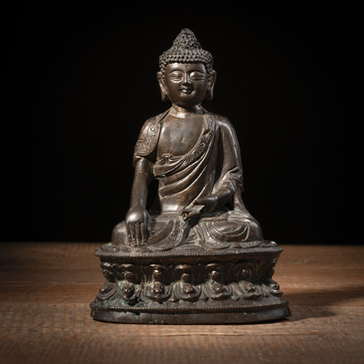 <b>A BRONZE FIGURE OF BUDDHA SHAKYAMUNI WITH RESIDUE OF GILDING</b>