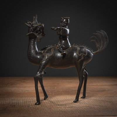 <b>A BRONZE CENSER OF A FIGURE RIDING A QILIN</b>