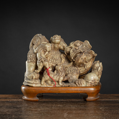 <b>A SOAPSTONE CARVING OF A BUDDHIST LION WITH CUBS</b>