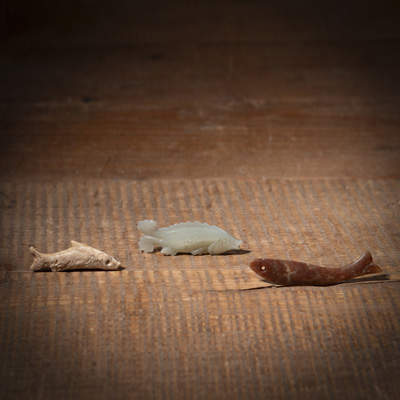 <b>THREE SMALL JADE CARVED FISH PENDANTS</b>