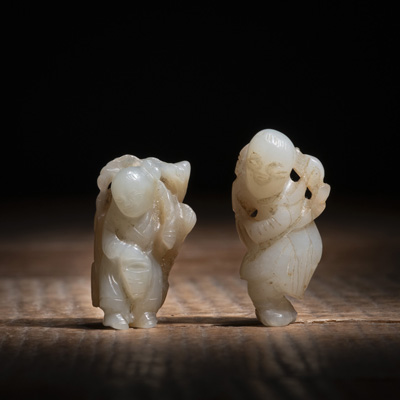 <b>TWO SMALL JADE CARVINGS: A BOY HOLDING A BASKET AND A MAN CARRYING A BRANCH</b>
