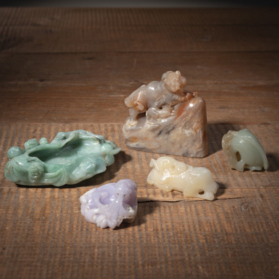 <b>FIVE JADE AND STONE CARVINGS: A BRUSH WASHER IN THE SHAPE OF A LOTUS LEAF, THREE ANIMAL CARVINGS AND A SOAPSTONE SEAL</b>
