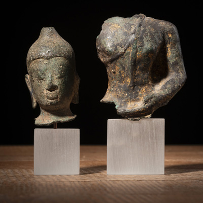 <b>A SMALL BRONZE HEAD AND TORSO OF THE BUDDHA</b>