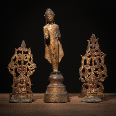 <b>A BRONZE FIGURE OF STANDING BUDDHA AND TWO GILT-BRONZE ALTAR ORNAMENTS</b>