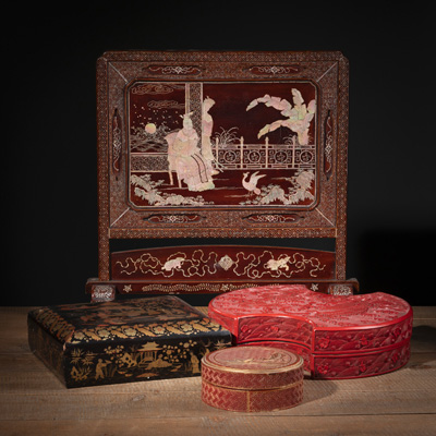 <b>LOT OF FOUR LACQUER ARTWORKS: A TABLE SCREEN WITH MOTHER-OF-PEARL INLAY, TWO REC CARVED LIDDED BOXES AN A GOLD PAINTED LACK LACQUER GAMING BOX AND COVER WITH FOUR INSIDE BOXES CONTAINING MOTHER-OF-PEARL GAME COUNTERS</b>