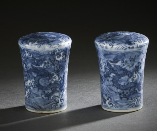 <b>A RARE PAIR OF IMPERIAL BLUE AND WHITE DRAGON SCROLL ENDS</b>