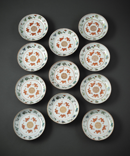 <b>A SET OF ELEVEN FAMILLE ROSE BAT AND SHOU SAUCERS WITH FLOWER BRANCHES</b>