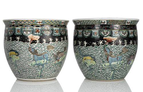 <b>A pair of 'Famille noir' cachepots with mythical creatures above porcelain waves</b> <b>A pair of 'Famille noir' cachepots with mythical creatures above porcelain waves</b>