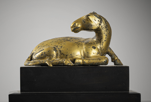 <b>A GILT-BRONZE FIGURE OF A RECLINING HORSE</b>