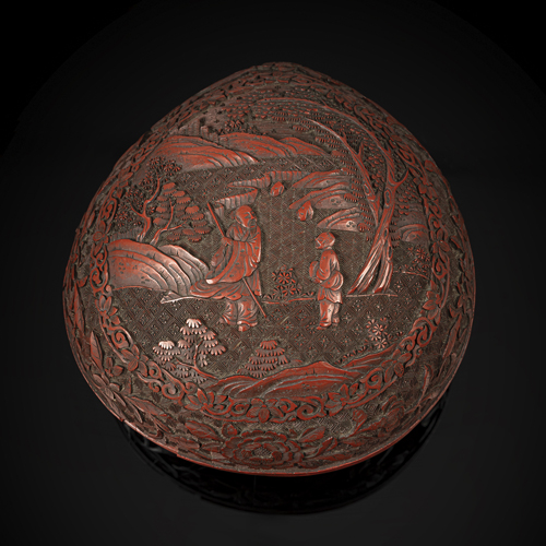 <b>A PEACH-SHAPED CINNABAR LACQUER BOX AND COVER WITH SCHOLAR AND PAGE BOY IN A LANDSCAPE</b>