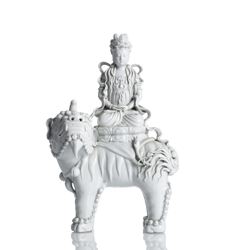 <b>A large Dehua figure of Majushri sitting on a lion above a lotus</b>