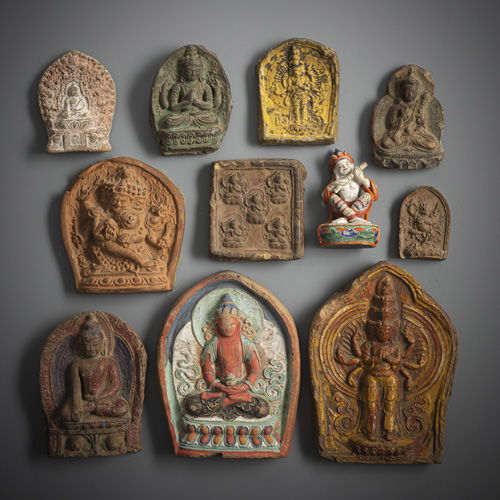 <b>Ten tsha tsha made of earthenware, partly glazed or gilded or coloured, and a polychrome wooden figure</b>