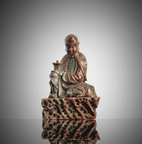 <b>A fine carved soapstone  figure of a Lohan sitting on a rock - Subinda</b>