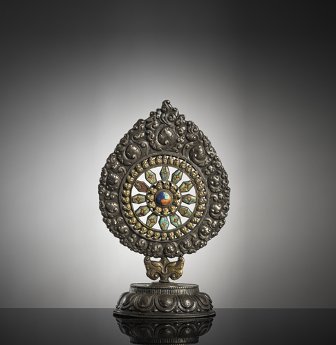 <b>A fine part-gilt silver altar emblem 'dharmacakra' with stone inlays</b>