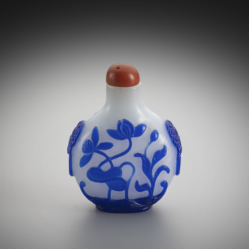 <b>A snuff bottle made of snowflake glass with blue overlay of lotus and orchids</b> <b>A snuff bottle made of snowflake glass with blue overlay of lotus and orchids</b>