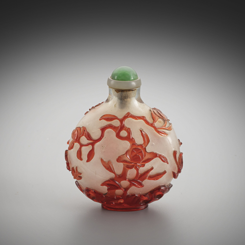 <b>A fine snuff bottle made of snowflake glass with red overlay of various flowers and branches over rocks</b> <b>A fine snuff bottle made of snowflake glass with red overlay of various flowers and branches over rocks</b>