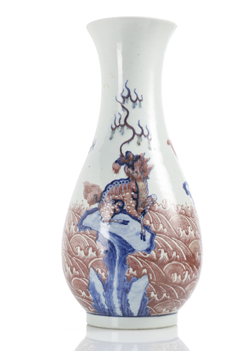 <b>A PEAR-SHAPED VASE WITH MYTHICAL CREATURES IN COPPER RED AND UNDERGLAZE BLUE OVER WAVES</b>