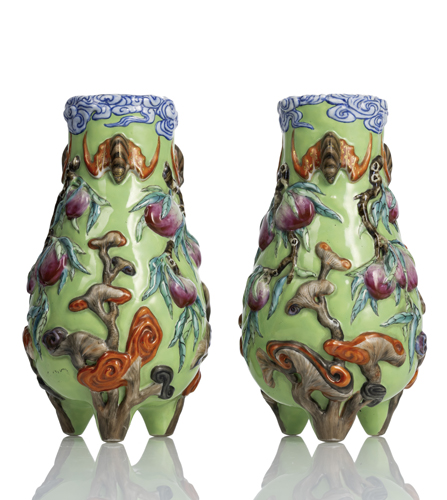 <b>A pair of rare porcelain vases with decoration of peach branches and bats over a green background in high relief</b> <b>A pair of rare porcelain vases with decoration of peach branches and bats over a green background in high relief</b>